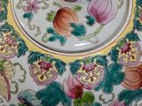 a bowl with a lid that has flowers and leaves on it