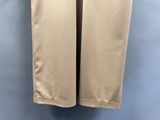 un gros plan sur un pantalon beige suspendu à un cintre