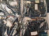 several pairs of jeans are wrapped in plastic bags on a table