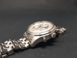 a watch that is sitting on a black surface
