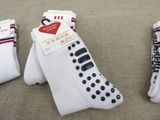 three pairs of white socks with red, white, and blue stripes