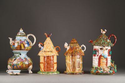 several different types of ceramic teapots are lined up on a table