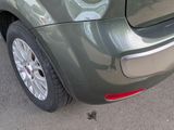 a close up of the rear end of a green car