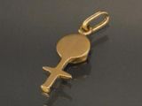 a close up of a gold key on a black surface