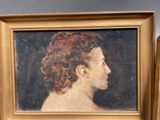 painting of a woman with curly hair in a gold frame
