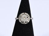 a close up of a diamond ring sitting on top of a black cone