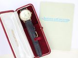 a watch in a red box with a black strap