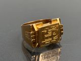 a gold ring that has a picture of a train on it