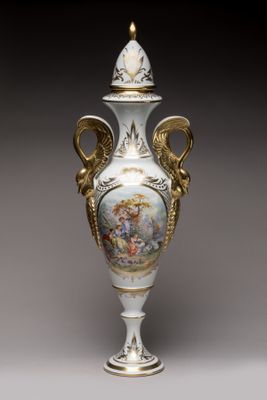 a white vase with a painting on it sitting on a table