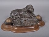a statue of a lion sitting on top of a table