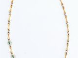 a close up of a necklace on a white surface