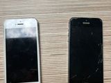 two cell phones sitting next to each other on a table