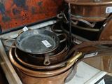 pots and pans on a stove with a painting in the background