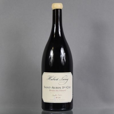 a bottle of wine sitting on top of a glass table