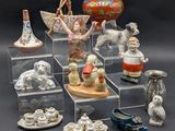 a lot of figurines that are sitting on a shelf