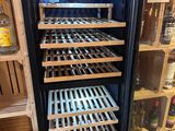 a refrigerator that has a lot of bottles of liquor in it