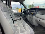 the interior of a truck with a seat folded down and a seat belt down