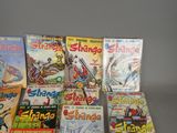 a lot of comic books sitting on a table