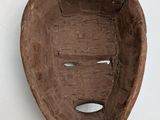 a wooden bowl with a banana in it on a table