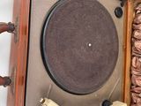 an old record player in a wooden case on a white surface