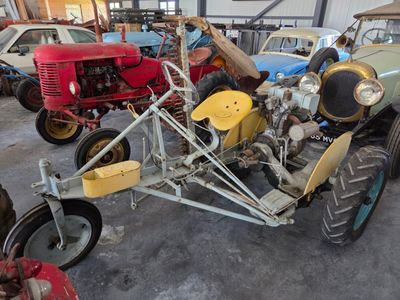 a man sitting on a tractor in a garage