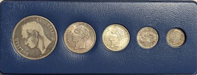 six different coins in a blue case with a white background