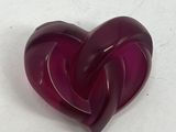 a purple heart shaped object on a white surface