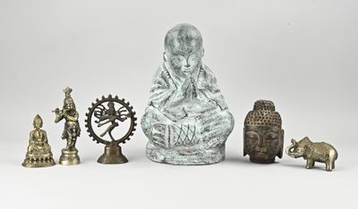 une statue représentant une femme assise sur une chaise, à côté d'autres statues