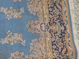 a blue rug with a gold border on it