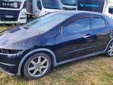 a picture of a car that is parked in the grass