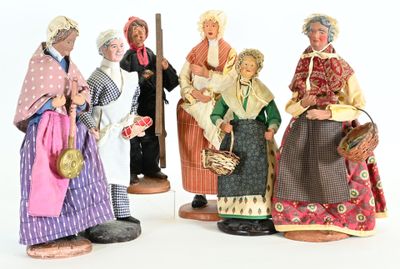 five figurines of people dressed in traditional clothing