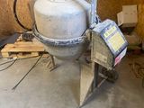 a cement mixer sitting in a room with a lot of wood