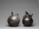 two vases sitting next to each other on a gray surface