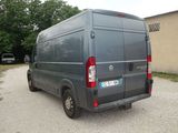 a grey van parked in a parking lot next to a building