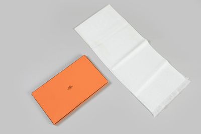 an orange and white box with a piece of paper next to it