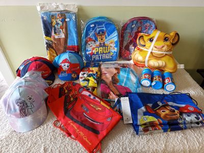 a lot of children ' s items on the bed