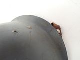 a close up of a helmet hanging on a wall