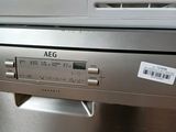 an image of a stainless steel dishwasher with a tag on it