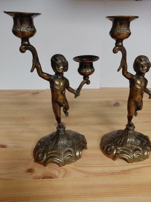 two candles that are sitting on a wooden table