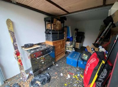 an image of a garage with a lot of stuff on the floor