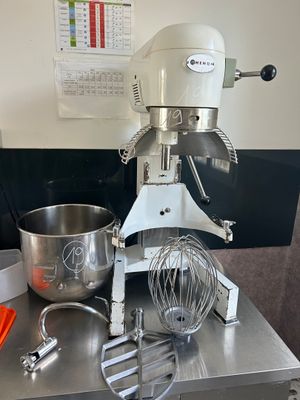 an image of a mixer on a table with a bowl and a whisk