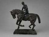 bronze statue of a man riding a horse on a marble base