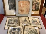 several framed and unframed pictures of people and buildings on a table