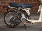 a motor bike that is parked in front of a brick wall