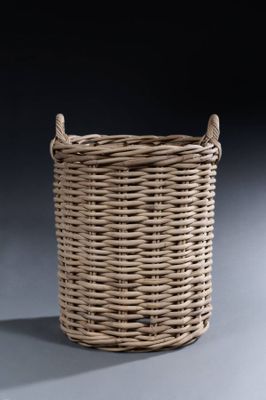 a large wicker basket with handles on a grey background
