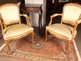 two chairs sitting next to each other on a rug