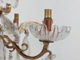 a chandelier that has a bunch of crystal hanging from it