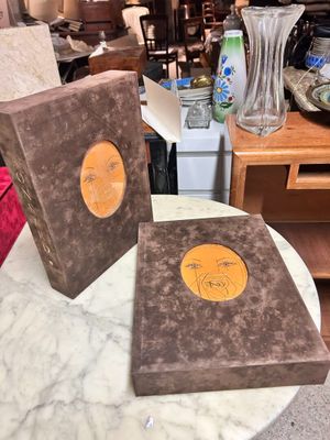 two books that are sitting on a marble table