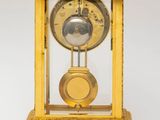 a golden clock that is sitting on a table