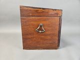an old wooden box with a bell on top of it